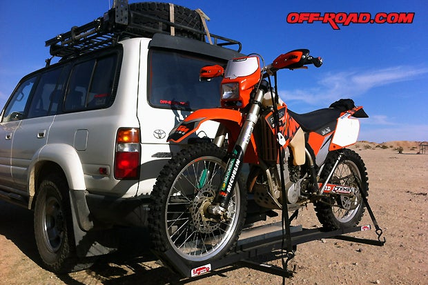The Joe Hauler dirt bike carrier uses a tow hitch mounting point to create a safe and sturdy platform for hauling a motorcycle behind your truck, Jeep or SUV.