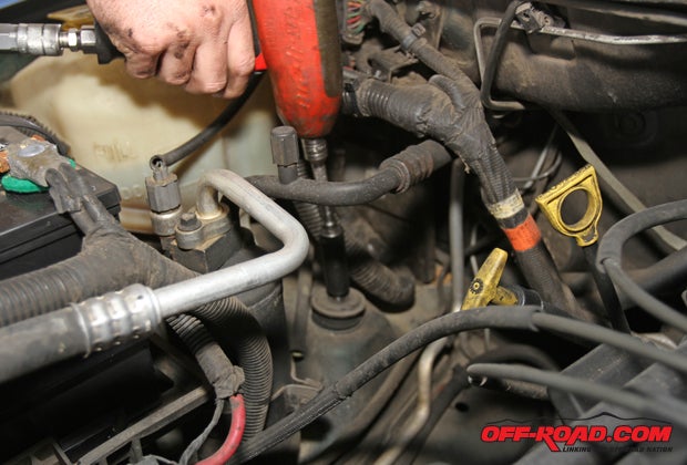 To access the top front shock mounts, lift the hood and loosen the top mounting bolt. 