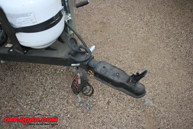 A 2-inch coupler is on the test trailer, which should be good for nearly any road or trailand it doesnt rattle or thump. However, if youd feel safer, a pintle hook-and-lunar ring or an articulating hitch are available as extra-cost options. Near the top of the image, the refillable 5-gallon liquid propane gas (LPG) container is mounted on the tongue.