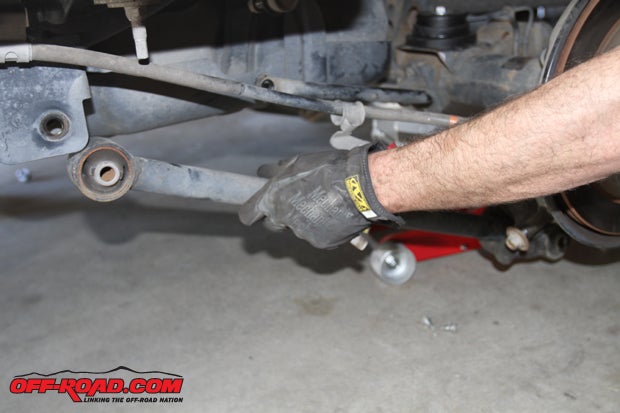 Before installing the spring itself, we shifted our attention to the lower trailing arm and began by removing the stock arm.
