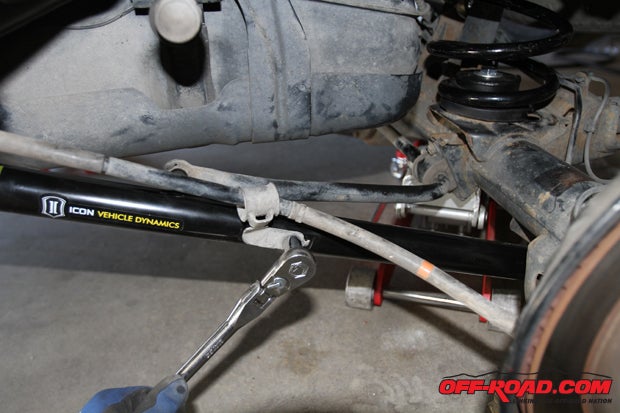 Reconnect the brake line to the new Icon lower control arm that is pre-drilled to accept the stock bolt.