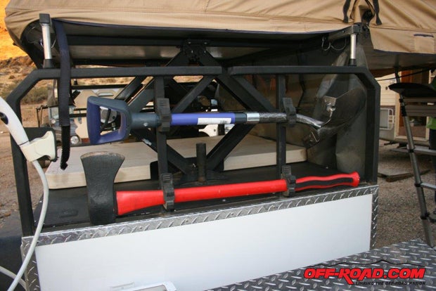 Above the toolbox is a mount for shovel and ax  its out of the way but easy to grab and use.