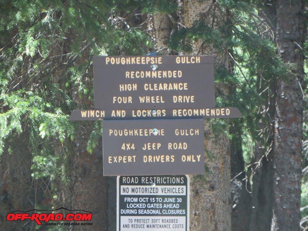 At a major crossroads on the Engineer Pass trail, this sign points the way to Poughkeepsie Gulch and warns potential travelers.