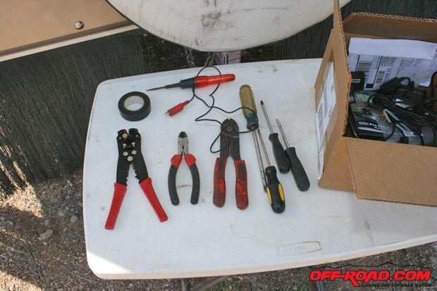 Youll need a fairly large selection of electrical hand tools such as these to complete the installation (wire stripper, circuit tester, plastic zip ties, dikes, pliers, screwdrivers, and electrical tape). Ive also found that its much more convenient to have a tablewhat off-roader doesnt have a camping table availableor rolling tray to hold drinks, tools, and materials.