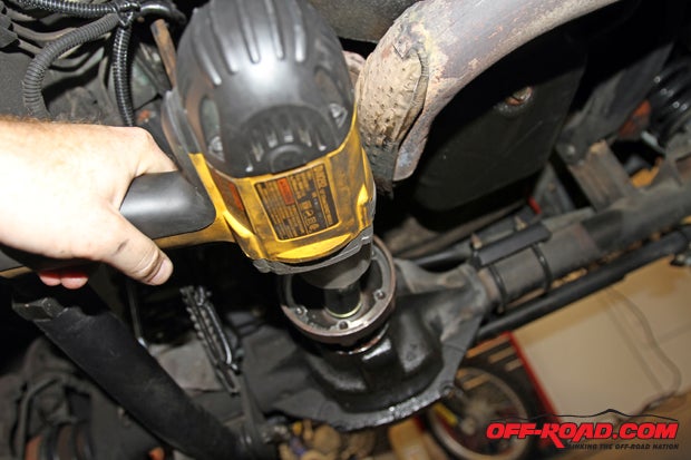 An impact gun makes removal of the pinion flange bolt much easier. Be sure to place an oil pan underneath the axle to catch any gear oil that drains out, and some gear oil on hand to replace any thats lost.