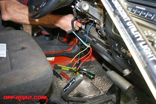 Dave Schupp of Precision Automotive is connecting the remote systems wiring loom to the Jeeps existing wiring.