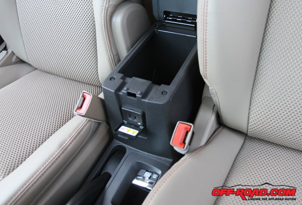 Under the center console storage compartment is a 12-volt outlet, and just below that is the silver lever to control the four-wheel-drive lock function to lock the center coupling in low-traction situations.
