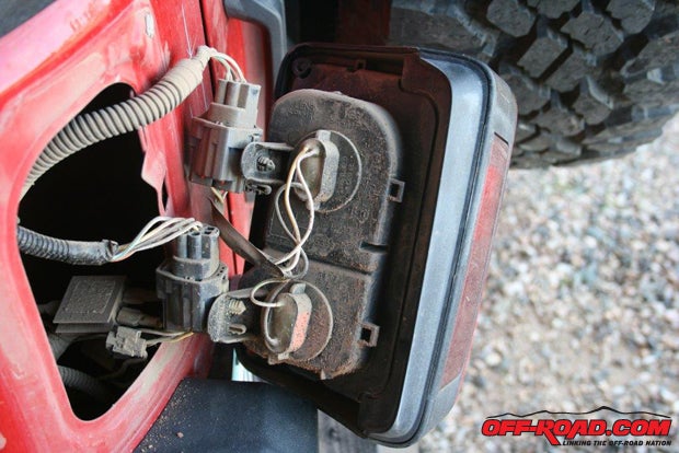 Remove the taillight assembly and ascertain the power line for the backup lights (in this case it was green/white) and the ground wire (black). Since many Jeep have fiberglass taillight assemblies you wont be able to just ground the camera and transmitter to the body, youll need a direct ground wire connection.