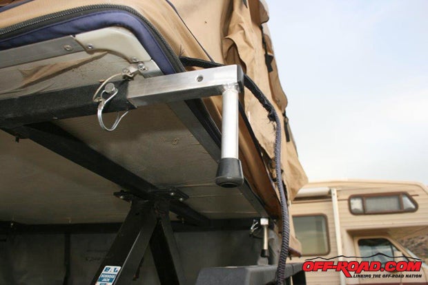 Once the tent platform is high enough, extend the support legs, re-pin them, and lower the legs down onto the safety rails. The safety rails protect the tent in case a condition of upset occurs; much like your Jeeps roll bar protects you.