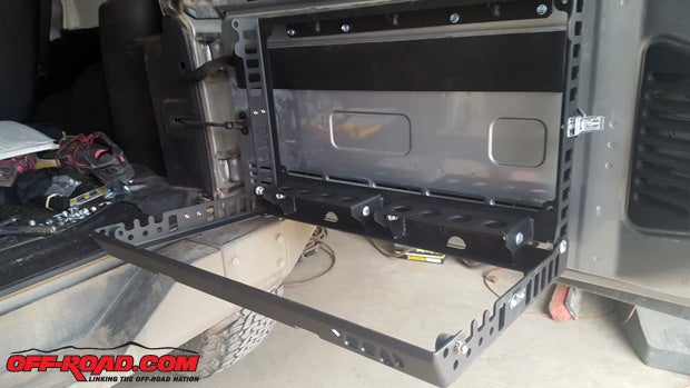 The tailgate table serves as both a secured storage container, and when stopped it will fold down for added space at the back end of the Jeep. 
